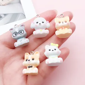 Detailed macro shot of five assorted cute 3D cartoon dog resin charms on a hand