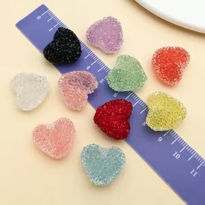 Close-up of colorful frosted acrylic heart beads next to a ruler for DIY craft jewelry.