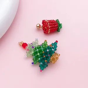 Detail of handmade beaded Christmas tree and bell charms with colorful crystal beads