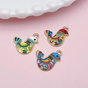 Detailed shot of three Bohemian style colorful enamel bird charms for DIY jewelry making.