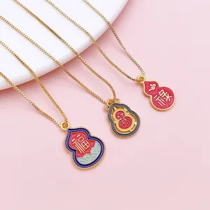 Detail of Chinese style gold Wu Lou gourd pendants with enamel lotus patterns