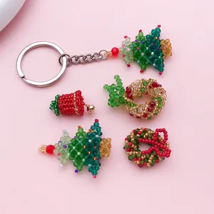 Close-up of handmade beaded Christmas charms including tree, wreath, and bell designs.