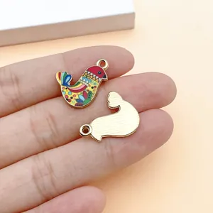 Detailed macro view of colorful ethnic style bird charms showing front and back texture