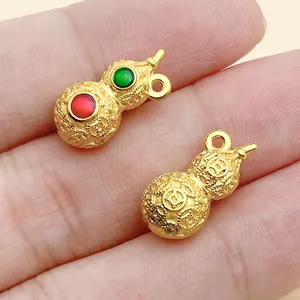 Detailed view of matte gold gourd pendants featuring intricate patterns and colorful enamel.
