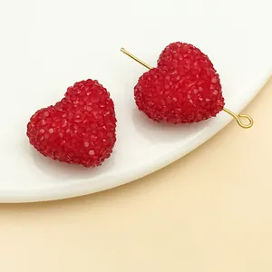 Detail macro of red heart sugar beads showing the frosted acrylic texture for DIY crafts