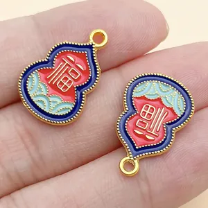 Detail of Chinese gourd charms with red and blue enamel and gold Fu character detail.