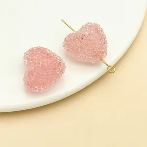 Detailed macro view of pink sugar-textured heart acrylic beads for DIY craft accessories