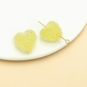 Close-up of yellow frosted heart-shaped sugar beads for DIY jewelry and hair accessories