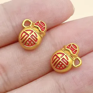 Macro detail view of gold-tone gourd charms featuring red 'Fu' character engraving