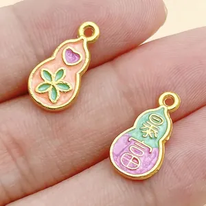 Detail view of enamel gourd charms with lucky Chinese characters for DIY jewelry