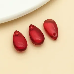 Macro detail of three red teardrop glass pendants for DIY handmade jewelry making