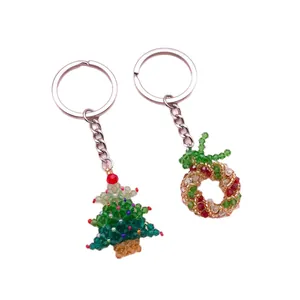 Exquisite handmade beaded Christmas tree and wreath keychain charms on white background