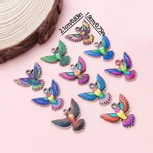 Detail view of colorful hummingbird charms with dimension markings for jewelry making.