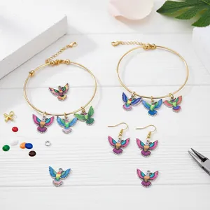 Close-up view of colorful hummingbird charms for DIY jewelry accessories with pliers