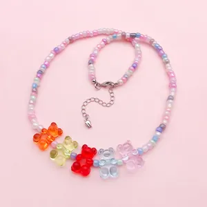 Close-up of colorful pastel beaded necklace with five transparent gummy bear charms