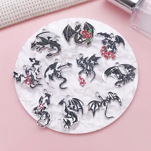 Detailed view of various vintage dark dragon pendants for DIY jewelry making art