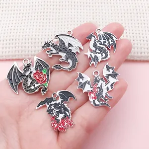 Detail view of various gothic dragon enamel charms with rose and fire breathing designs