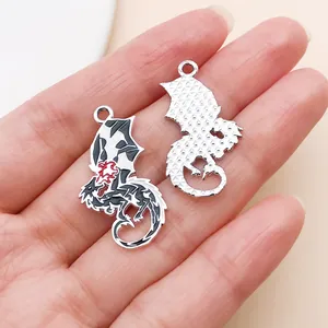 Close-up showing the intricate front enamel and textured back of Western dragon charms