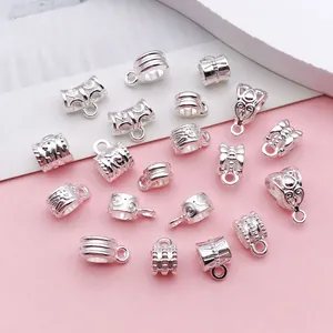 Close-up of silver vintage alloy bail beads with intricate patterns for DIY jewelry