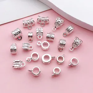 Detailed view of various silver vintage patterned bail beads for DIY jewelry making