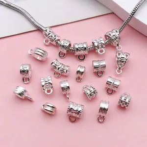 Detailed view of bright silver vintage pattern jewelry bail beads for DIY bracelets
