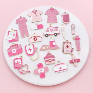 Macro view of diverse pink medical enamel charms like nurse hats and stethoscopes for DIY craft.