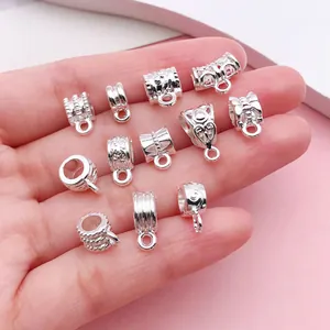 Detailed view of antique silver bail beads in various patterns for DIY jewelry