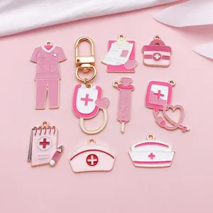 Detailed view of pink enamel medical charms including nurse hat and syringe for DIY jewelry