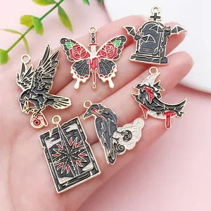 Detailed view of dark gothic enamel pendants featuring crow, butterfly and tombstone motifs