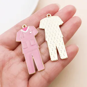 Detailed macro view of pink enamel nurse scrub charms for DIY jewelry making projects