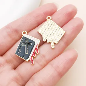 Detailed macro view of gothic bible charm with cross and blood drip for DIY jewelry