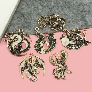 Detailed view of mythical creature enamel charms for dark fantasy DIY jewelry projects.