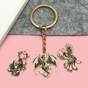 Detailed view of dark fantasy dragon and phoenix alloy charms for DIY keychain designs