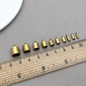 Close-up of golden metal tassel caps in various sizes for DIY jewelry making