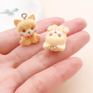 Macro detail showing two cute resin Corgi dog charms for DIY jewelry and keychains.