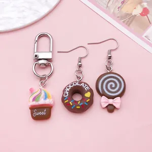 Macro detail of cute resin chocolate dessert charms featuring donut and ice cream