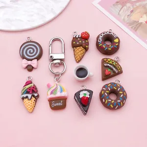Close-up of assorted resin dessert charms including donuts and ice cream cones for DIY
