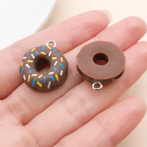 Macro detail view of chocolate donut resin charms with colorful sprinkles for DIY jewelry