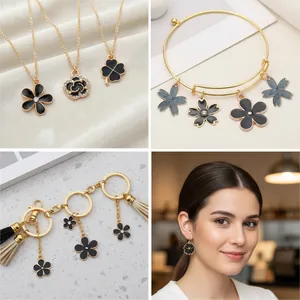 Detailed macro view of black enamel flower and clover charms for DIY jewelry design