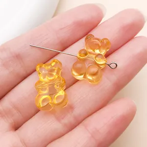 Transparent orange gummy bear beads with horizontal holes for DIY jewelry making.
