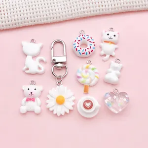 Selection of white resin charms including cat, bear, donut and daisy for DIY jewelry