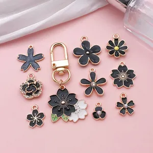 Macro view of assorted black enamel flower charms for DIY jewelry making accessories