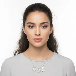 Close-up of model wearing a silver necklace featuring resin heart donut and bear charms