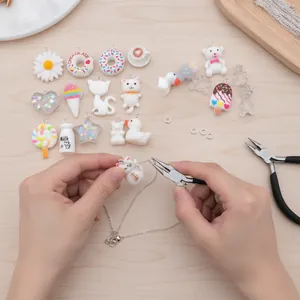 Close-up of white resin animal and food charms used for DIY jewelry making assembly.