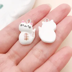 Close-up of front and back white resin cat charm for DIY jewelry making accessories