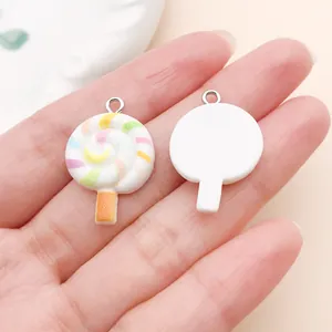 Detail view showing front and back of colorful swirl resin lollipop charms.