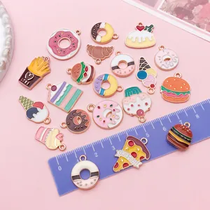 Colorful enamel dessert charms for DIY projects shown with a ruler for size reference.