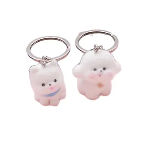 Juego de dos lindos llaveros de perro blanco flocado para accesorios de bolsos y moda