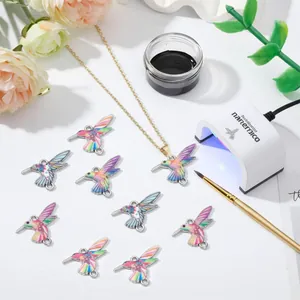 Detailed view of colorful hummingbird alloy pendants and DIY necklace crafting accessories.