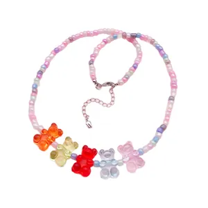Colorful acrylic gummy bear beaded necklace with pastel round beads on white background